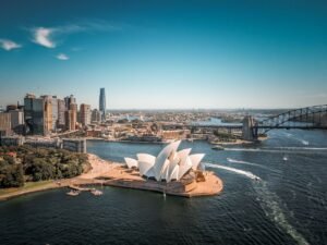 Breathtaking aerial view of Sydney Opera House with surrounding skyline and Harbor Bridge.
