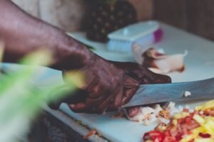 Close-up of a chef chopping fresh ingredients indoors in Nassau, Bahamas.