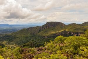 A beautiful vista of green mountains under a cloudy sky, showcasing natural beauty.