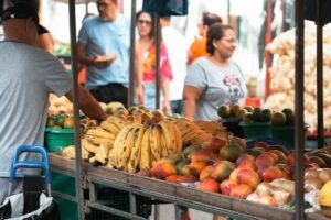 Colorful display of fresh fruits at a bustling market in Espírito Santo, Brazil.