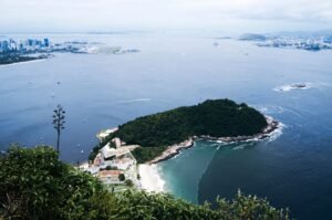 Breathtaking aerial view of Rio de Janeiro's beautiful coastline featuring urban skyline and lush greenery.
