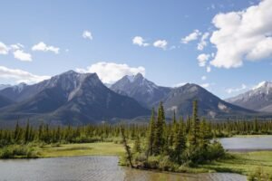Stunning view of snow-capped mountains and lush green forests in Jasper National Park.