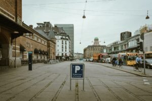Street view of Copenhagen featuring classic architecture, transport, and city life.
