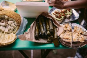 A variety of traditional Filipino delicacies and a sliced jackfruit on a table, offering a taste of tropical flavors.