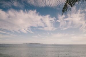 Tranquil ocean scene at Nadi, Fiji with striking clouds and gentle waves.