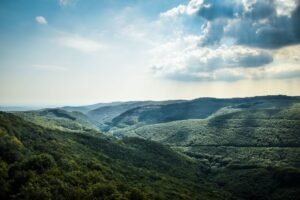Breathtaking landscape of Bükk Mountains with lush forests under a vibrant sky in Miskolc, Hungary.