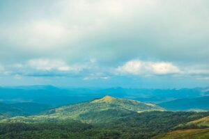 Breathtaking view of the Western Ghats in Chikkamagaluru, Karnataka, India with lush greenery and tranquil skies.