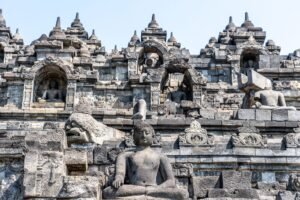 Close-up view of ancient stone sculptures and architecture at Borobudur Temple, Indonesia.