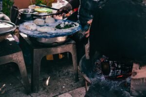 Experience traditional baking with dough and charcoal oven setup outdoors in Amman, Jordan.