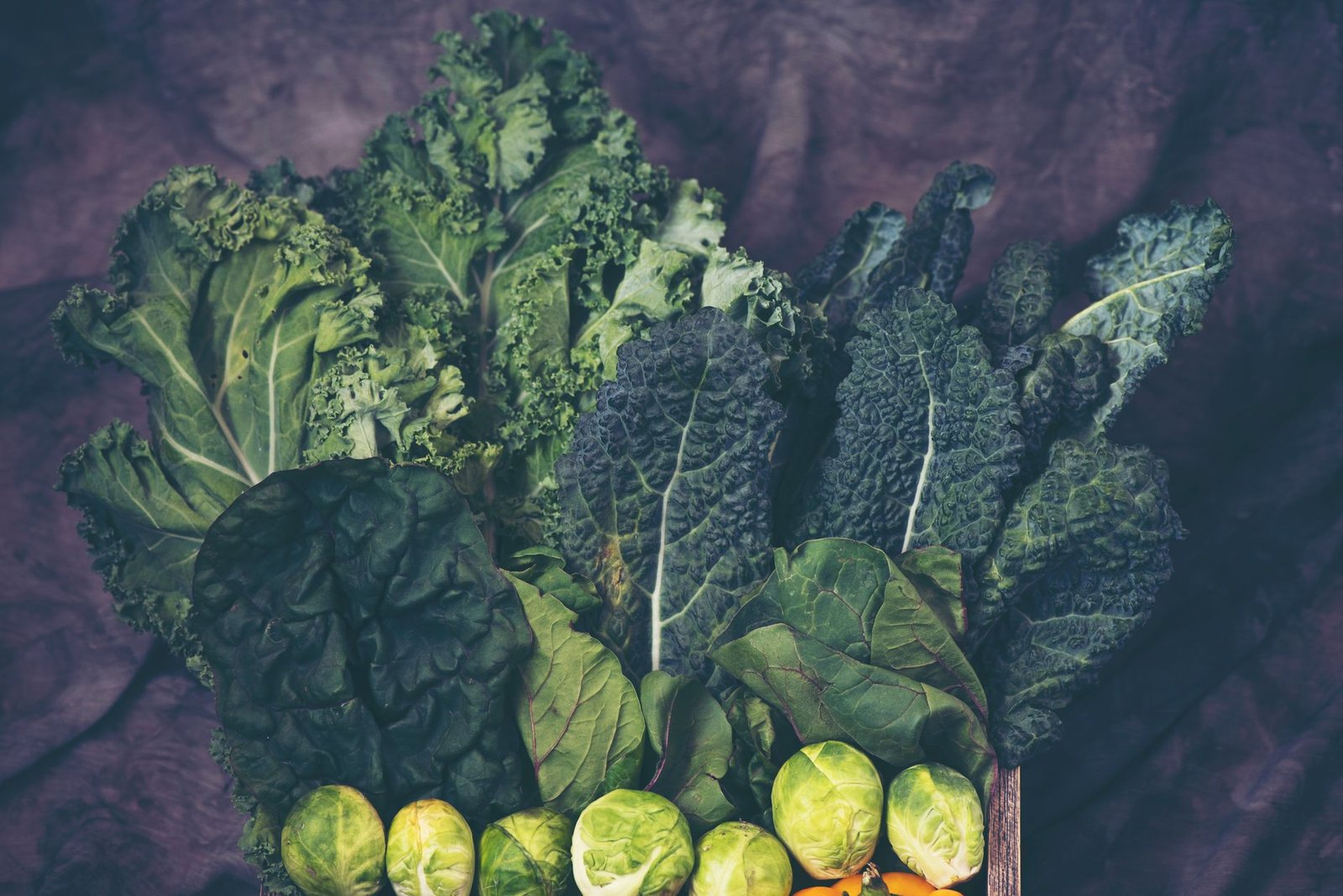 A vibrant assortment of fresh kale and Brussels sprouts showcasing healthy greens.