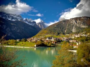 Beautiful autumn view of Molveno village and lake with mountains in Trentino, Italy.