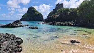 Crystal clear waters and rocky formations of Fernando de Noronha's stunning coastline.