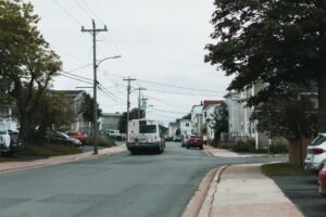 A serene neighborhood view with a bus on a street in St. John's, NL, Canada.