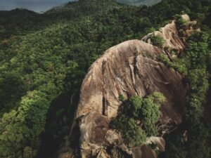 Striking aerial view of lush forest and rugged mountains in Ko Pha-ngan, Thailand.