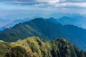 Breathtaking view of lush green mountains under a cloudy sky.